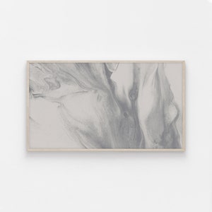 May include: A framed abstract painting with swirling gray and white paint. The painting is in a light wood frame.