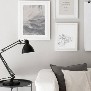 May include: Three framed prints on a white wall. The left print is a gray abstract design. The middle print has a quote that reads "If you look for the darkness that's all you will ever see. But if you look for the light often you will find it." The right print is a black and white image of a flower.