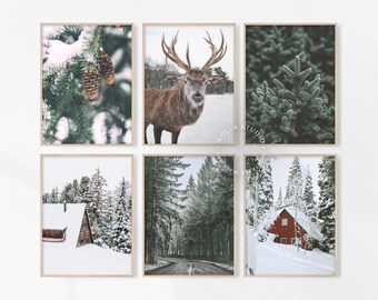 May include: Set of six winter-themed prints featuring snowy landscapes, pine trees, and a red deer. The prints are framed in a light wood frame.