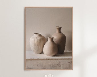 May include: Three ceramic vases in various shades of beige and brown, arranged on a textured surface. The vases are all different shapes and sizes, with one being taller and narrower than the others.