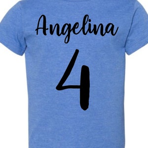 May include: A blue t-shirt with the name "Angelina" and the number "4" printed in black.