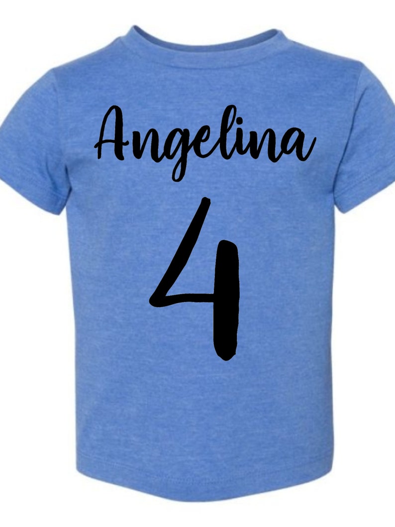 May include: A blue t-shirt with the name "Angelina" and the number "4" printed in black.