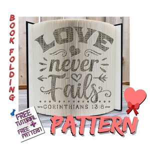May include: A book with pages folded to display the words "LOVE never Fails" with a heart and arrow design. The text "CORINTHIANS 13:8" is below. A pink heart with a red bow is on the right. The words "BOOK FOLDING" and "PATTERN" are also visible.