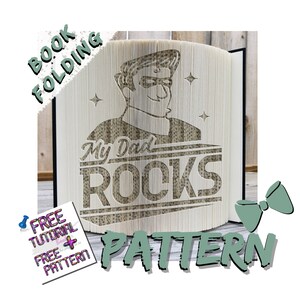 May include: A book folding pattern featuring a cartoon illustration of a person with the text "My Dad Rocks". The pattern is printed on white paper and is ready to be folded into a 3D book sculpture.
