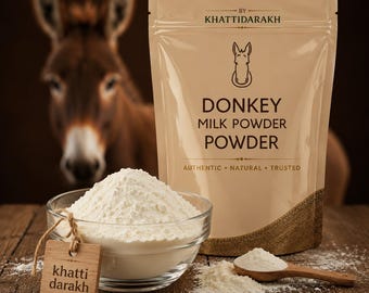 May include: A beige pouch labeled BY KHATTIDARAKH DONKEY MILK POWDER POWDER AUTHENTIC NATURAL TRUSTED with a donkey illustration. A glass bowl filled with white powder and a wooden tag reading khatti darakh sit beside a wooden spoon of powder.