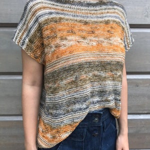 May include: A striped knit top with a loose fit and short sleeves. The top is made in a blend of orange, brown, and gray yarn.