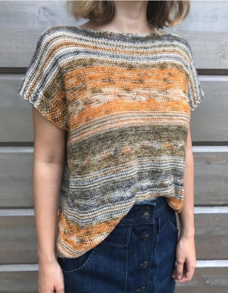 May include: A striped knit top with a loose fit and short sleeves. The top is made in a blend of orange, brown, and gray yarn.