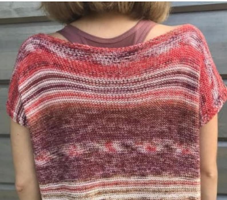 May include: A striped, short-sleeved, knit top in shades of red, orange, and brown.