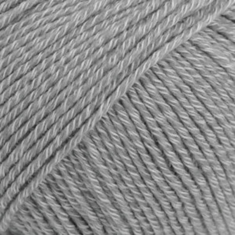 May include: A skein of light gray yarn.