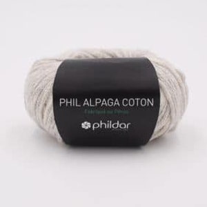Może przedstawiać: Motka beżowej przędzy z etykietą "Phil Alpaga Coton" i logo PhilDar.