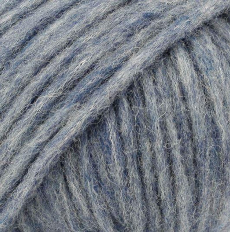 May include: A ball of yarn featuring a blend of deep navy blue and light heather gray fibers. The yarn has a fuzzy, brushed texture with visible strands twisted together, creating a multi-tonal appearance throughout the entire surface of the ball.