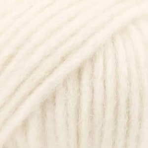 May include: A skein of off-white yarn featuring a soft, fuzzy texture with visible twisted plies. The yarn is wound in a dense, uniform pattern, showcasing a light cream color throughout the entire surface of the fiber bundle.