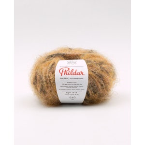 May include: A ball of Phil Leo yarn with a leopard print effect. The yarn is a mix of brown, tan, and black. The label reads "Phil Leo Effet Imprime Leopard" and lists the fiber content and weight of 1.76 oz (50g).