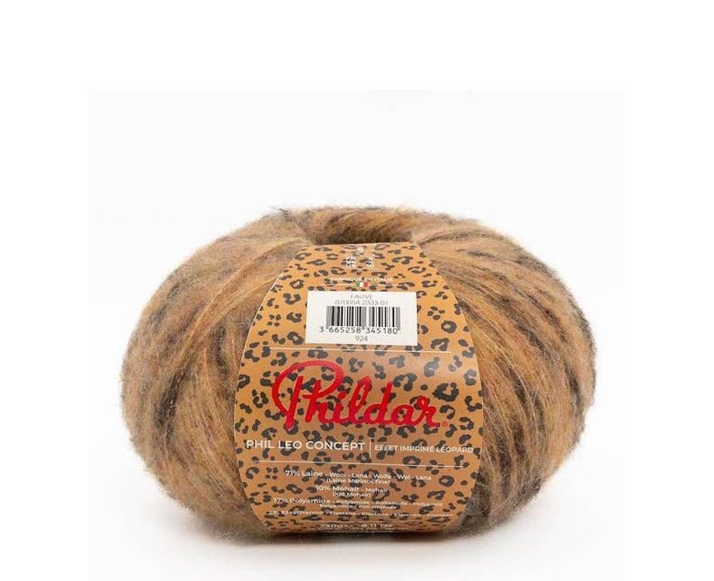 May include: A ball of brown, black, and orange yarn with a leopard print label. The label reads "Phil Leo Concept" and "Effet Imprime Leopardo".