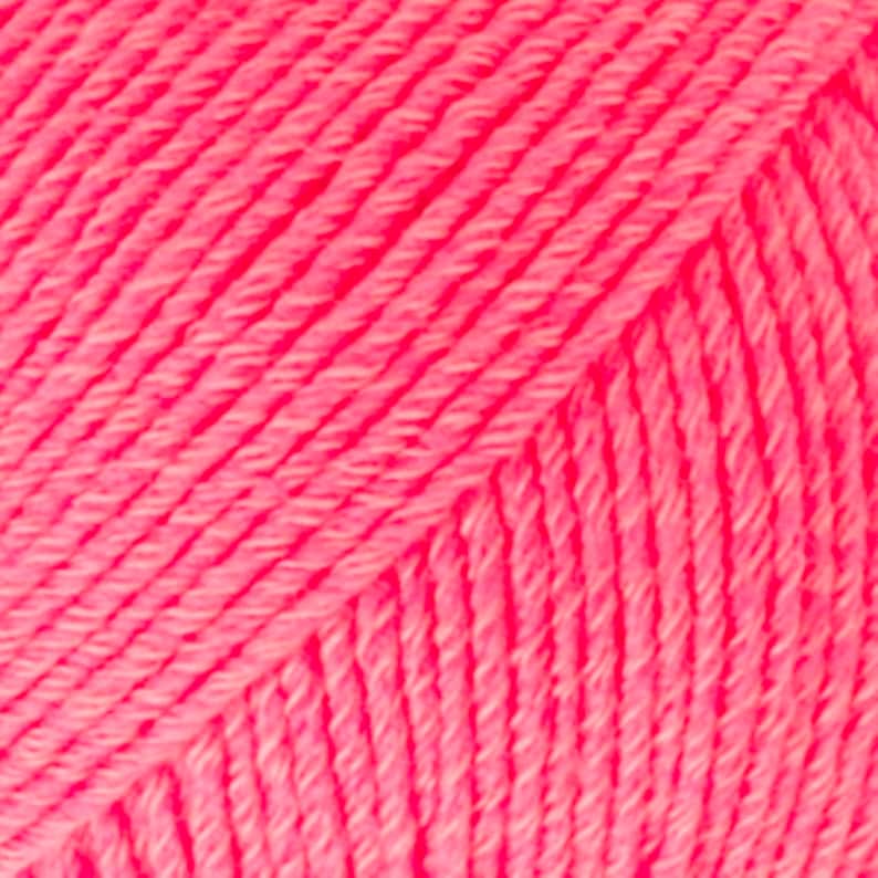 May include: Close-up of a bright pink yarn skein. The yarn is soft and fluffy, with a slightly textured surface.