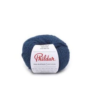 May include: A ball of navy blue Phildar yarn with a white label. The label features the brand name and product details. The yarn appears soft and textured, suitable for knitting or crochet projects.