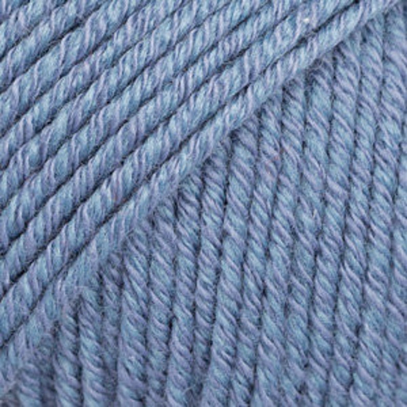May include: A skein of light blue yarn.
