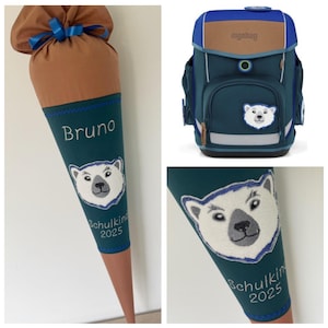 Könnte beinhalten: Ein Schulranzen- und Schultüten-Set. Die Schultüte ist türkis mit einem Eisbären-Design und dem Namen "Bruno". Der Rucksack ist türkis, blau und braun mit einem Eisbären-Patch. Die Schultüte ist mit "Schulkind 2025" beschriftet.