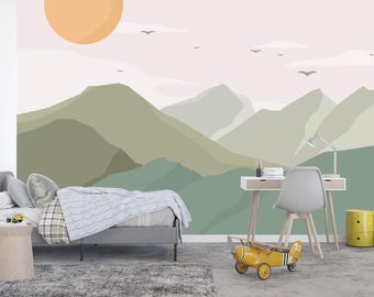 May include: A wall mural featuring a stylized mountain landscape in shades of sage green and olive, set against a pale pink sky with a large orange sun and small black birds flying in the distance, creating a serene and expansive outdoor scene.