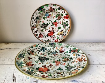 Pair of vintage floral tin plates; made by Nevco and Daher