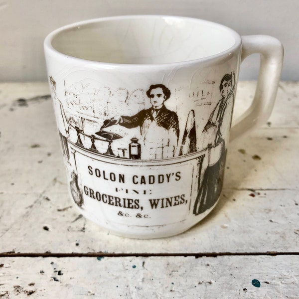 Vintage Carrigaline Pottery mug with Solon Caddy's Groceries advertisement
