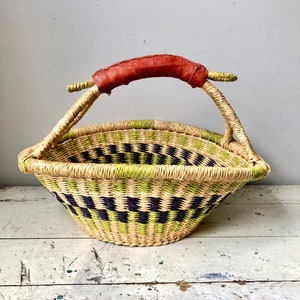 Woven Bolga basket with leather-wrapped handle