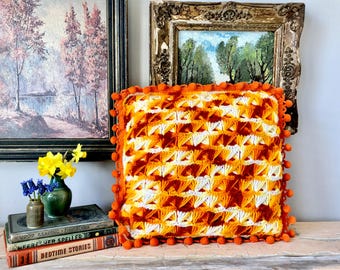 Vintage crochet pillow with pom-pom trim