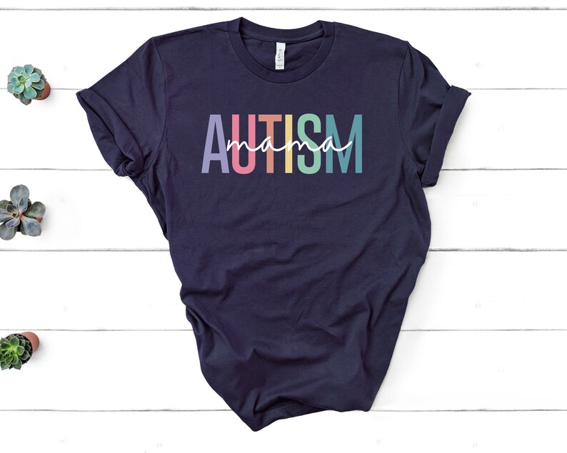 May include: A navy blue t-shirt with the text "AUTISM mama" in rainbow colors.