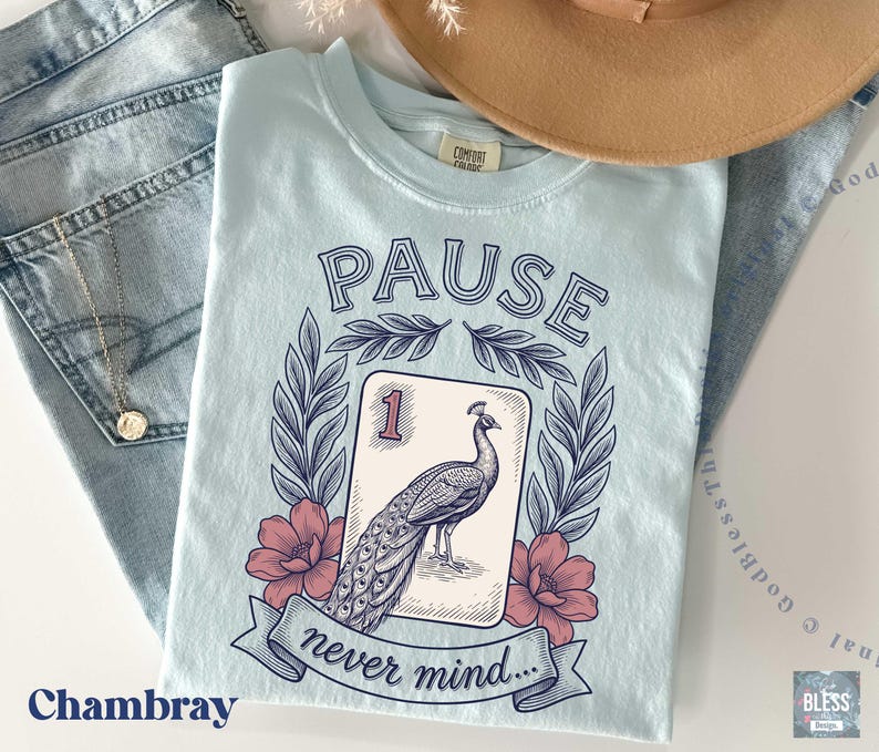 A unisex Comfort Colors t-shirt featuring a retro floral peacock mahjong tile graphic and the funny phrase Pause Nevermind.