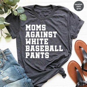 May include: Heather dark grey t-shirt with the text "MOMS AGAINST WHITE BASEBALL PANTS" printed in white.