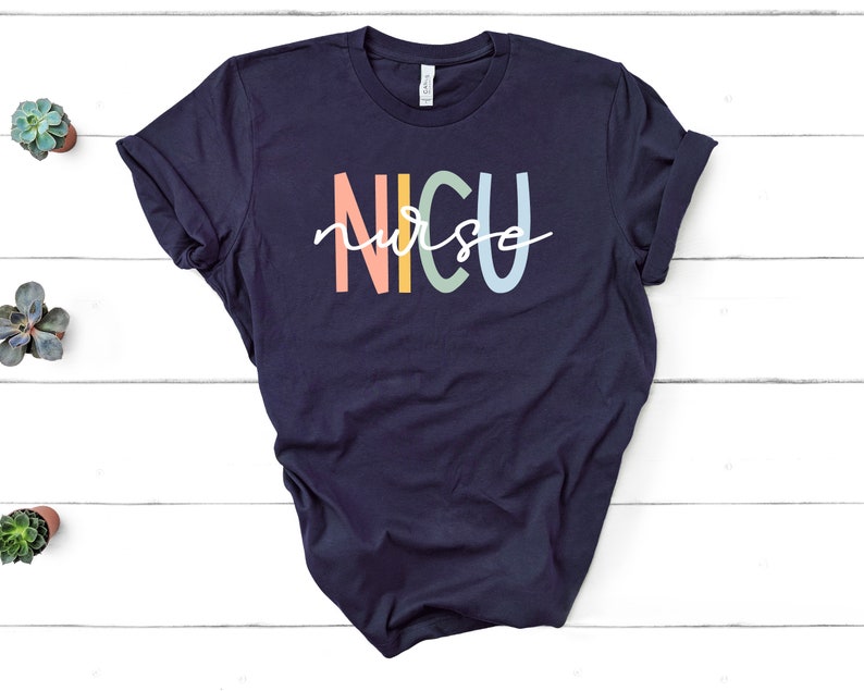 May include: A navy blue t-shirt with the text "NICU nurse" in rainbow colors. The text is in a stylized font.