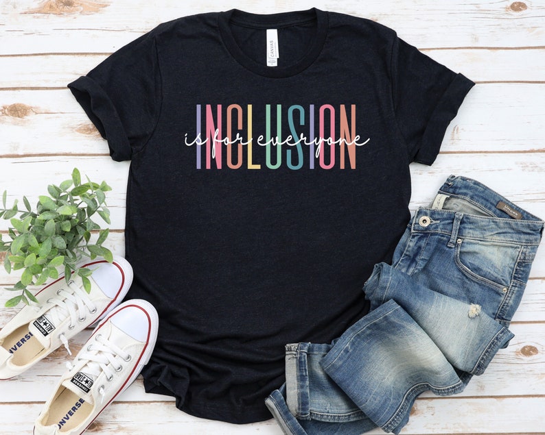 May include: A black t-shirt with the text "Inclusion is for everyone" in rainbow colors.
