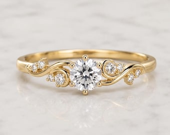 May include: A yellow gold ring featuring a central round brilliant-cut white diamond held by four prongs. The band displays a swirling, vine-like design on both sides, accented with six smaller round white diamonds embedded along the curves.