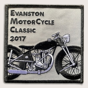 May include: A black and white embroidered patch featuring a vintage motorcycle with the text "Evanston Motorcycle Classic 2017".