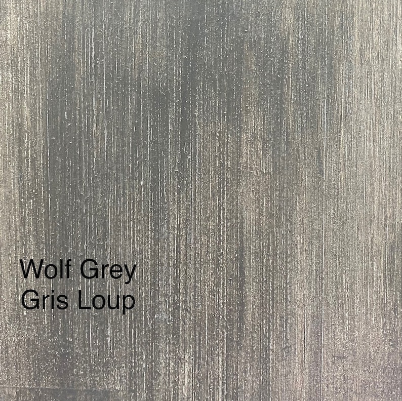 May include: Close-up of a textured surface in a wolf grey color. The surface has vertical lines and the words "Wolf Grey" and "Gris Loup" are printed on the surface.