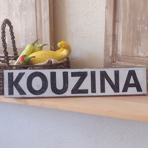 Kouzina Greek Kitchen Sign on wood shelf. Vintage Shutters. Basket of Fresh vegetables, vintage shot glass with mint clippings