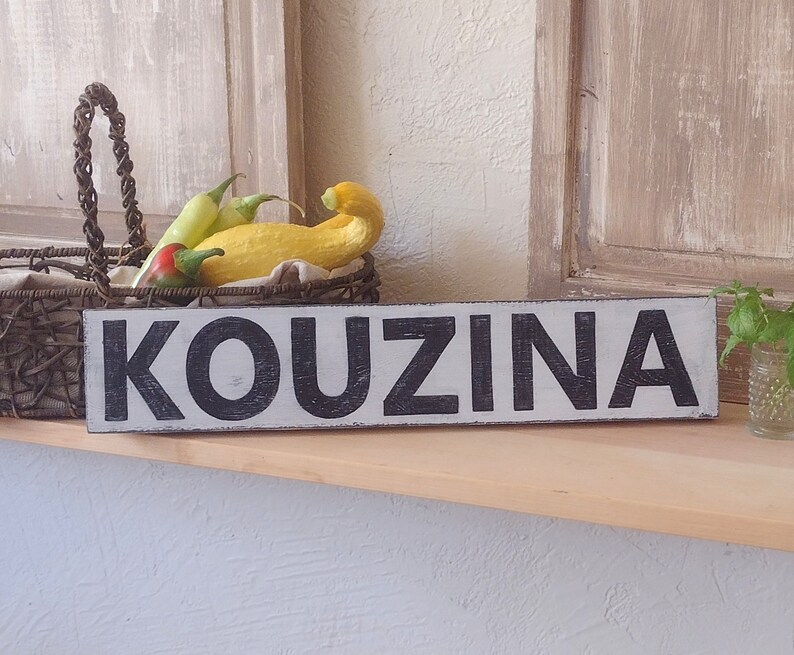 Kouzina Greek Kitchen Sign on wood shelf. Vintage Shutters. Basket of Fresh vegetables, vintage shot glass with mint clippings