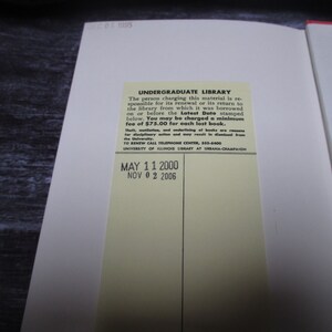 May include: A yellow library card with black text. The text reads "UNDERGRADUATE LIBRARY" and includes instructions for returning library materials. The card also includes the dates "MAY 11 2000" and "NOV 02 2006".