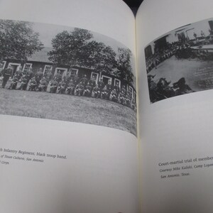 May include: A black and white photograph of a group of men in military uniform standing in front of a building. The men are arranged in rows and are all looking at the camera. The building is a simple wooden structure with a few windows. The photograph is titled "Twenty-fourth Infantry Regiment, black troop band." and is credited to the US Signal Corps.
