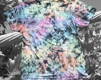 May include: A short-sleeved t-shirt with a tie-dye pattern in a variety of colors, including black, pink, blue, green, and orange. The shirt has a crew neck and a casual style. The tie-dye design is swirled and blended.