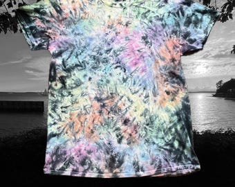 May include: A tie-dye t-shirt with a black, blue, pink, green, and orange swirl pattern.