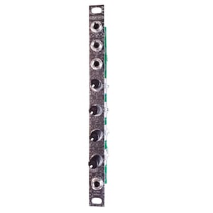 May include: A silver-coloured metal panel with a black and white pattern. The panel has six black knobs and six silver jacks. The text "TIPTOP AUDIO" is printed on the panel.