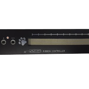 May include: Black Waveform Ribbon Controller with a paw print logo and a silver ribbon control strip. The controller has three jacks and a power indicator light.