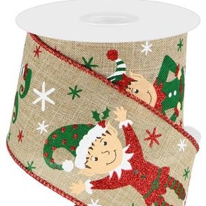 May include: A roll of Christmas ribbon with a burlap texture. The ribbon features a repeating pattern of elves, snowflakes, and the word "Joy". The edges are trimmed with red glitter.