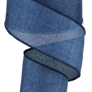 May include: A roll of denim-look ribbon with a white core. The ribbon is a deep blue color with a textured appearance and dark blue stitched edges. This decorative ribbon is suitable for crafts and gift wrapping.