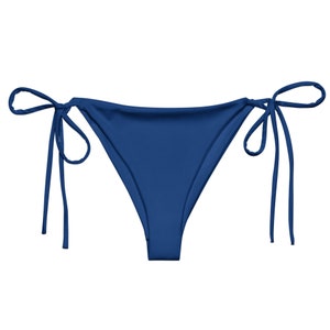 May include: A blue bikini bottom with adjustable ties on the sides.