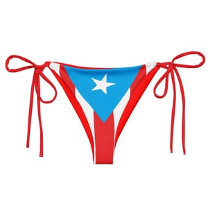 May include: A red, white, and blue bikini bottom featuring the flag of Puerto Rico. The bikini bottom has a triangular shape with red ties on each side. The design includes a blue triangle with a white star.