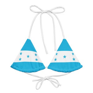 May include: A blue and white bikini top with a triangle shape and white straps. The top features the flag of Honduras.