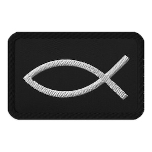 May include: A rectangular black embroidered patch featuring a white stitched Christian fish symbol in the center. The patch has a thick black border with visible stitching along the edges, creating a clean and defined rectangular shape.