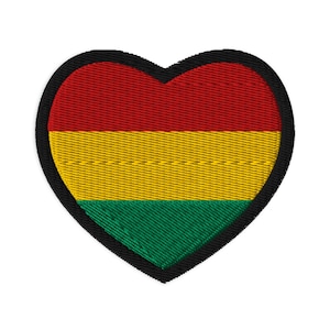 May include: Embroidered heart-shaped patch featuring the colors of red, yellow, and green, with a black border. The patch has a textured appearance, suggesting it is made of fabric or thread.